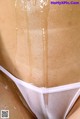 A close up of a woman's butt covered in oil.